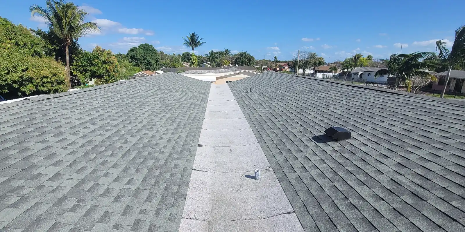 Close-up of a clean, well-maintained shingle roof valley ensuring proper drainage